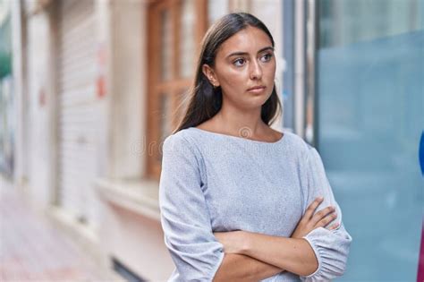 Young Beautiful Hispanic Woman Standing With Serious Expression And