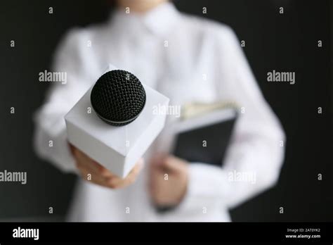 Female journalist with microphone, closeup Stock Photo - Alamy