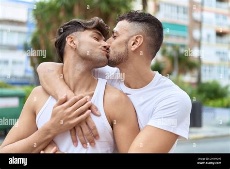 Two Hispanic Men Couple Hugging Each Other And Kissing At Street Stock