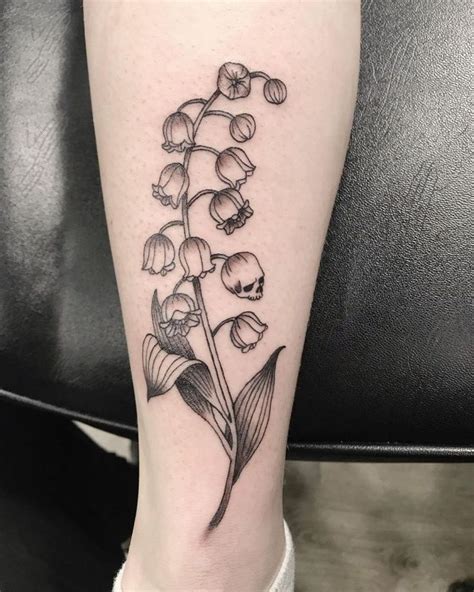 A Black And White Flower Tattoo On The Leg