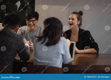 Business People At Meeting Desk In Cafe Multiethnic Motivated Teamwork