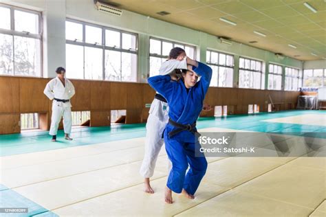young female judo athlete attacking  nage waza throwing technique