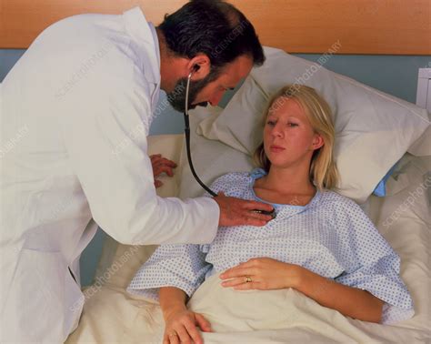 Doctor Using Stethoscope On Woman