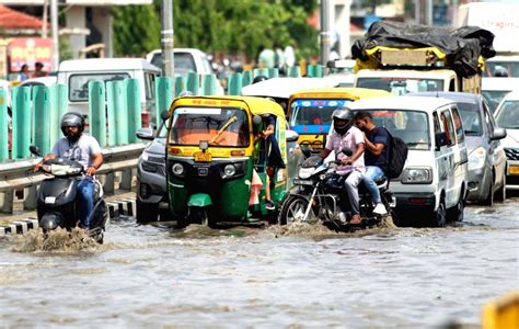 Lucknow Commuters Wade Through A Waterlogged At Sultanpur Road After