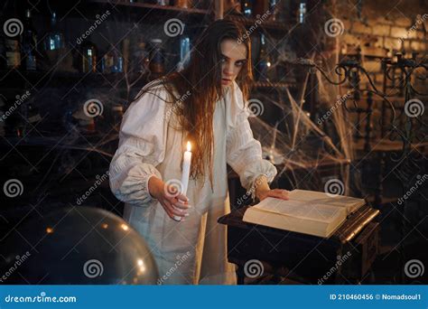 Demonic Woman With Candle Reads Book Of Spells Stock Photo Image Of