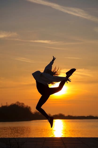 Premium Photo | Silhouette of person jumping at sunset