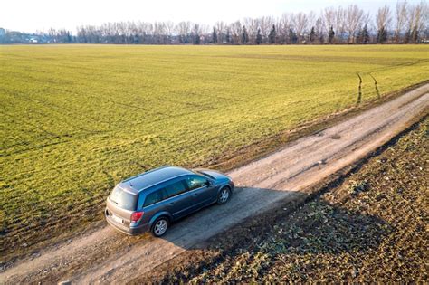 Premium Photo Aerial View Of Car Driving By Straight Ground Road