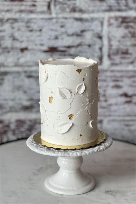 White Boho Textured Buttercream Cake With Gold Leaf By Layered Cake