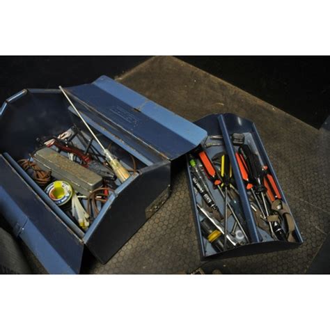 A Metal Toolbox And Two Trays Containing Tools Including A Record