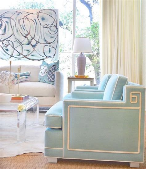 A Living Room With Couches Chairs And A Table In Front Of A Window