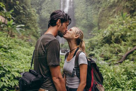 Shot Of Loving Young Couple Kissing While Standing In The Forest