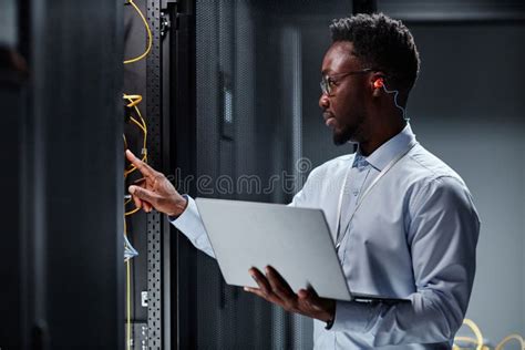 Young Network Engineer Working With Servers In Data Center And Holding