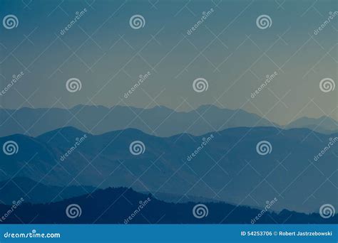 Misty mountains at sunrise stock photo. Image of light - 54253706