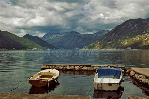 A Seascape With Two Fishing Boats Against The Backdrop Of Mountains