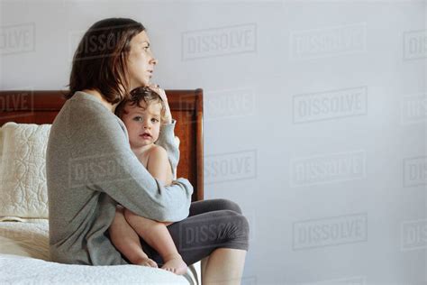 Caucasian Mother Hugging Son On Bed Stock Photo Dissolve