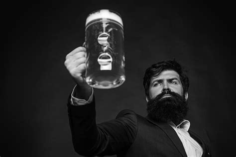 Premium Photo Handsome Barman Holding A Pint Of Beer Hipster Relaxing