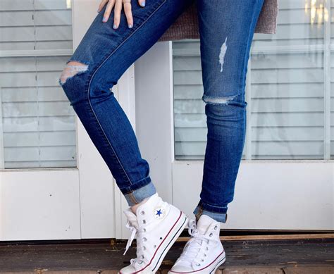 person  blue denim jeans  white converse  stars  stock photo