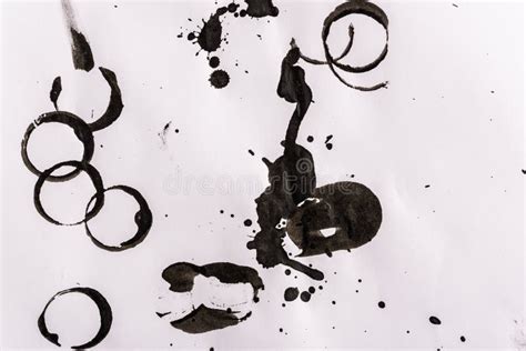 Untidy Concept Spots And Splashes Of Black Ink Spilled On White Paper