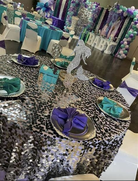 The Table Is Set With Purple And Blue Decorations Silver Sequins And