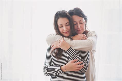 Beautiful Daughter Hugged By Her Mother With Their Eyes Closed By