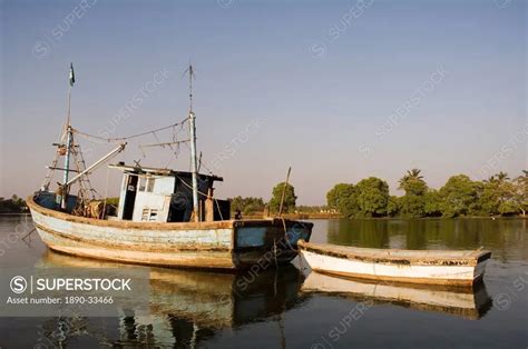 Fishing boats on backwater near Mobor, Goa, India, Asia - SuperStock