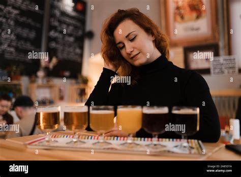 Redhead Woman Does A Degustation Of A Variety Of Light And Dark Czech