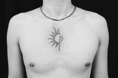 Fine line sun and moon tattoo on the chest