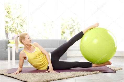 Doing strengthening exercises at home. Stock Photo by ©Sepy 101103394