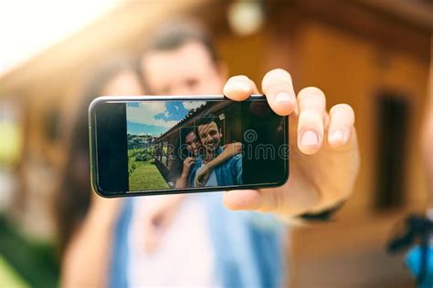 Some Moments Will Last A Lifetime An Affectionate Young Couple Taking Selfies Outside With