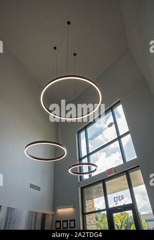 Large Circular Lights Hanging From The Ceiling Inside A Doctor S Office