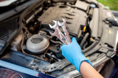 Auto Mechanic Works And Repairs Car Engine In Mechanics Garage Car