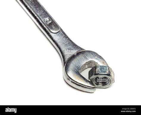 Wrench with nut isolated on white background Stock Photo - Alamy