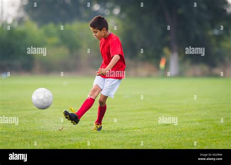 boy kicking soccer ball  sports field stock photo alamy