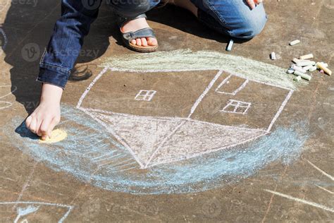 girl drawing a house with crayons on pavement 12256756 Stock Photo at Vecteezy