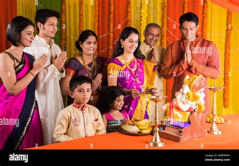 Indian family performing ganesh puja on ganesh chaturthi or ganesh ...