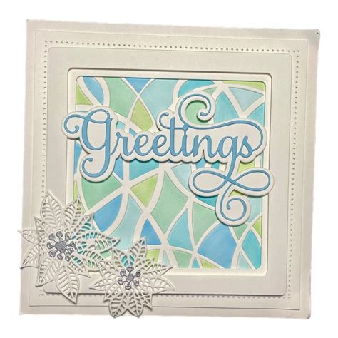 A Card With The Words Greetings Written In Blue Green And White