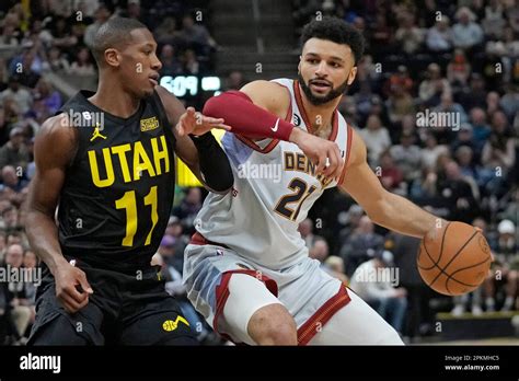 Utah Jazz Guard Kris Dunn Defends Against Denver Nuggets Guard