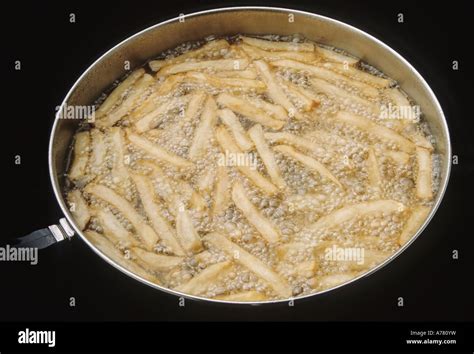 French Fries in Cooking Oil Stock Photo - Alamy