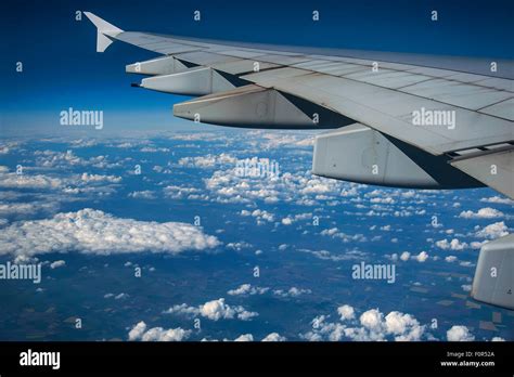 Wing of an Airbus A380-800, flying above the clouds, cumulus clouds ...