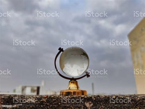 Picture Of A Globe Made Of Glass Shot On A Cloudy Day Depicting The Weather Is Fun To Go Out For