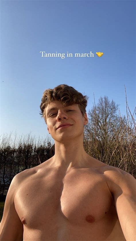 A Man With No Shirt Standing In Front Of A Blue Sky And The Words