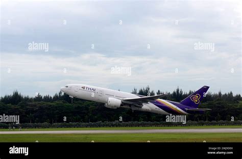 A Thai Airways Airplane Taking Off From Changi Airport In Singapore