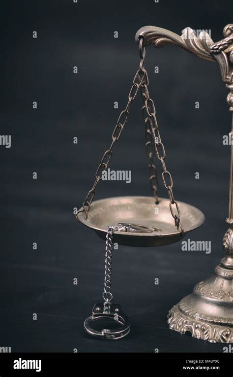 Law And Justice Legality Concept Scales Of Justice And Handcuffs On A