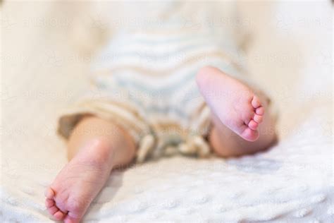 Image of Happy baby feet kicking during tummy time on change table ...