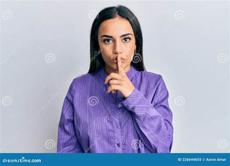 Young Brunette Woman Wearing Casual Clothes Asking To Be Quiet With Finger On Lips Stock Image