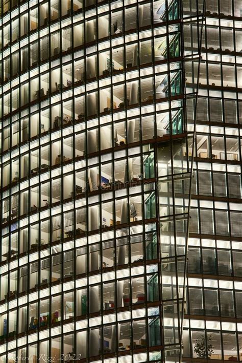 Detail Of A Fully Illuminated Building Office Facade Full Of Windows At