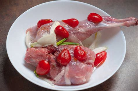 Raw Rabbit Meat Rear Leg Cuts Of Hare Seasoned With Fresh Onion