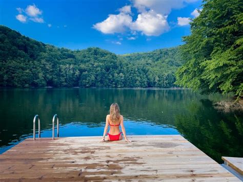 Premium Photo Woman In Red Bikini Sitting Down On A Wooden Pontoon