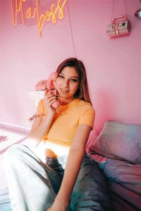 Portrait Of Young Attractive Cheerful Woman Sitting In A Bedroom With