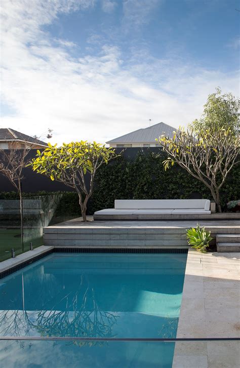 Raised Decking Above Pool With A Built In Lounge Chair And Frangipani